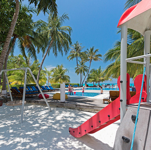 parque infantil y piscina en el resort Meeru Maldives